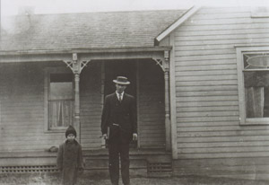 Dad and father David in front of their home in East Swede Town